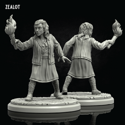 Two unpainted fantasy tabletop miniatures shown from front and back on a dark reflective background. The figures are wearing long coats and boots and each holds a flaming staff.