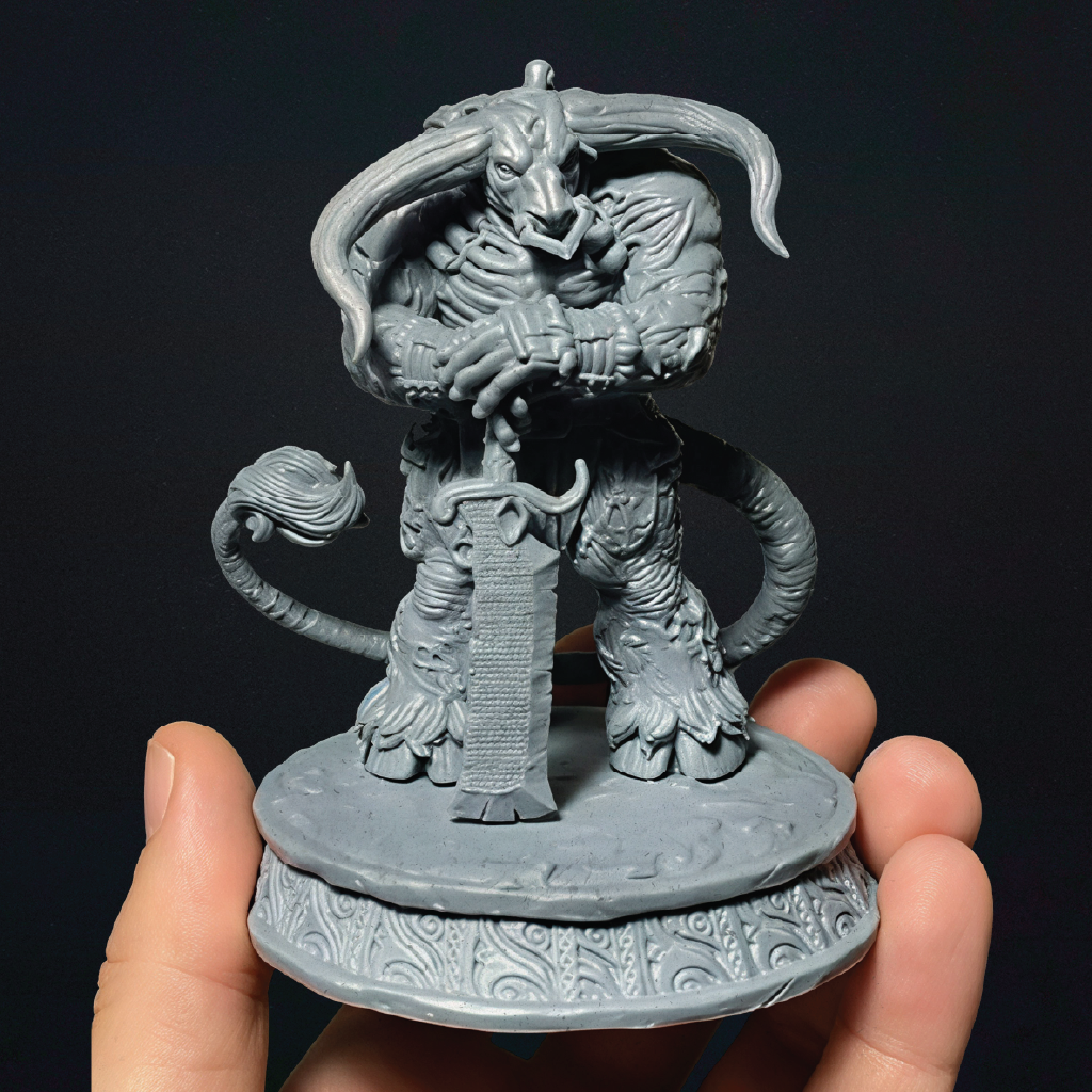 An unpainted 3D print of a zombie minotaur standing guard wielding a greatsword as a staff in front of him