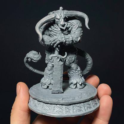 An unpainted 3D print of a zombie minotaur standing guard wielding a greatsword as a staff in front of him